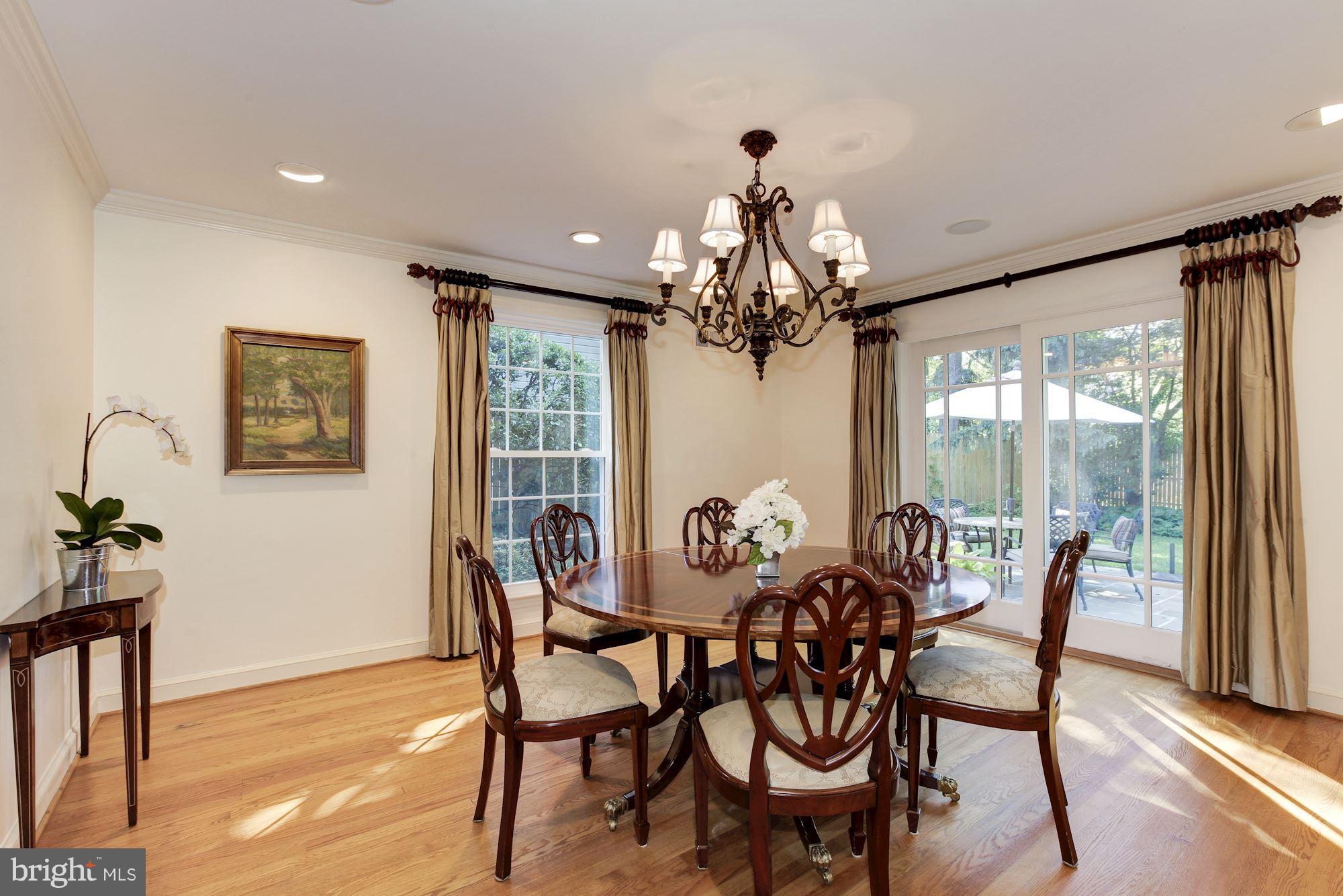 5509 Center Street Chevy Chase, MD 20815 - Photo 6 of 30 a view of a dining room with furniture wooden floor and chandelier