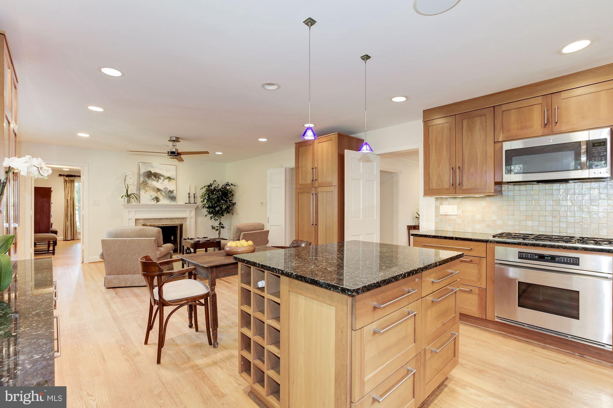 5509 Center Street Chevy Chase, MD 20815 - Photo 10 of 30 a kitchen with stainless steel appliances granite countertop a stove a sink and a refrigerator