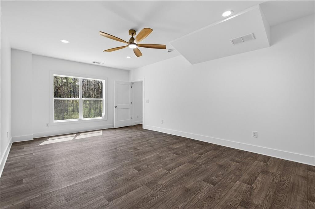 88 Carolyn Path Rockmart, GA 30153 - Photo 49 of 73 an empty room with wooden floor fan and windows