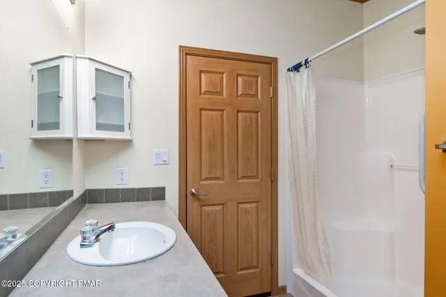 a bathroom with a bathtub and a shower