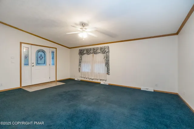 a dining room with a wooden table and chairs