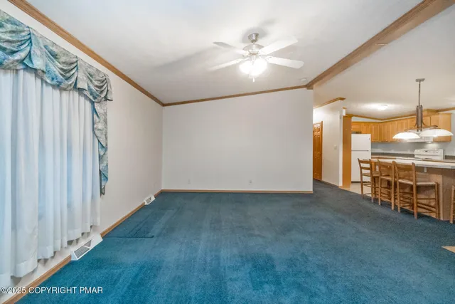 a view of an empty room with window and cabinet
