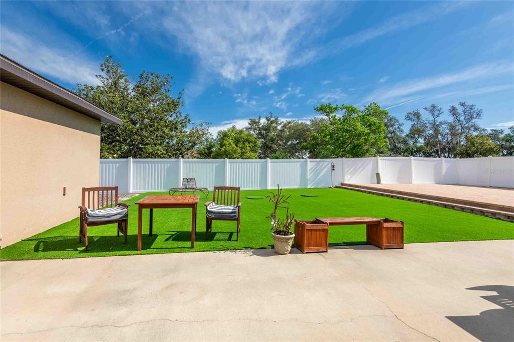 Undisclosed Address Spring Hill, FL 34608 - Photo 20 of 39 a view of backyard with a garden and seating area