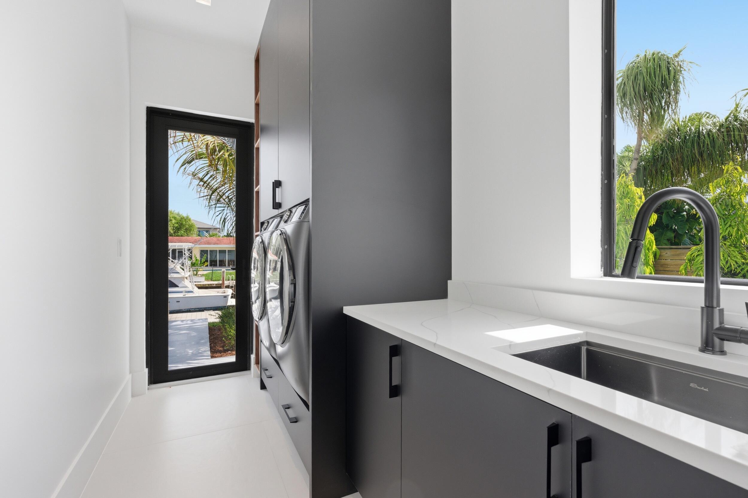 2360 Northeast 49th Street Lighthouse Point, FL 33064 - Photo 30 of 66 a view of a sink a refrigerator and a window