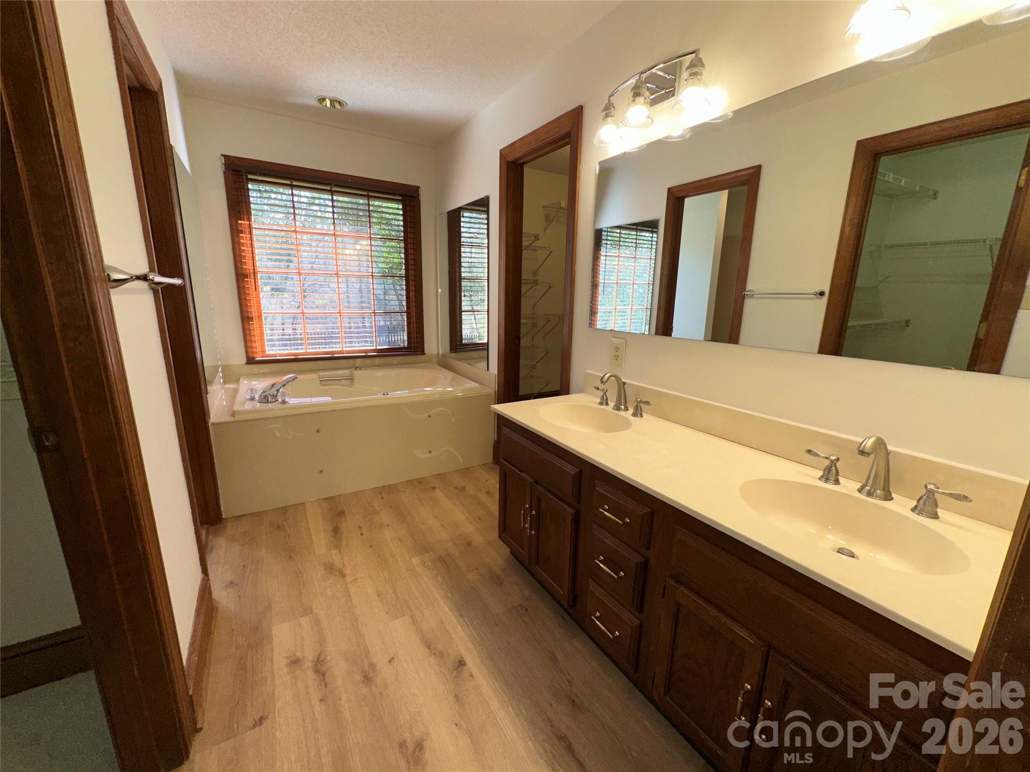 5143 Mintridge Road Mint Hill, NC 28227 - Photo 19 of 35 a bathroom with a double vanity sink a mirror and a bathtub
