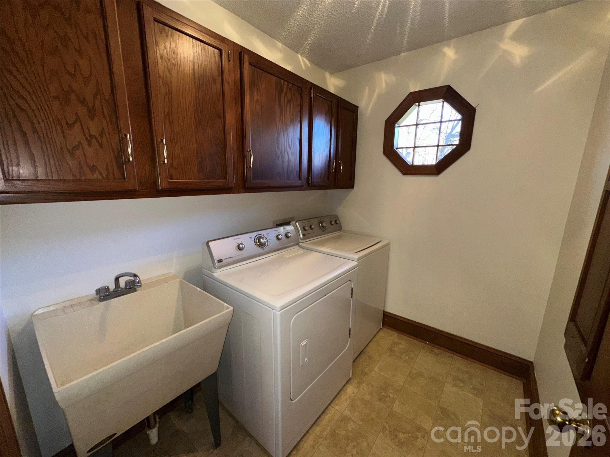 5143 Mintridge Road Mint Hill, NC 28227 - Photo 22 of 35 a utility room with a sink a washer and dryer