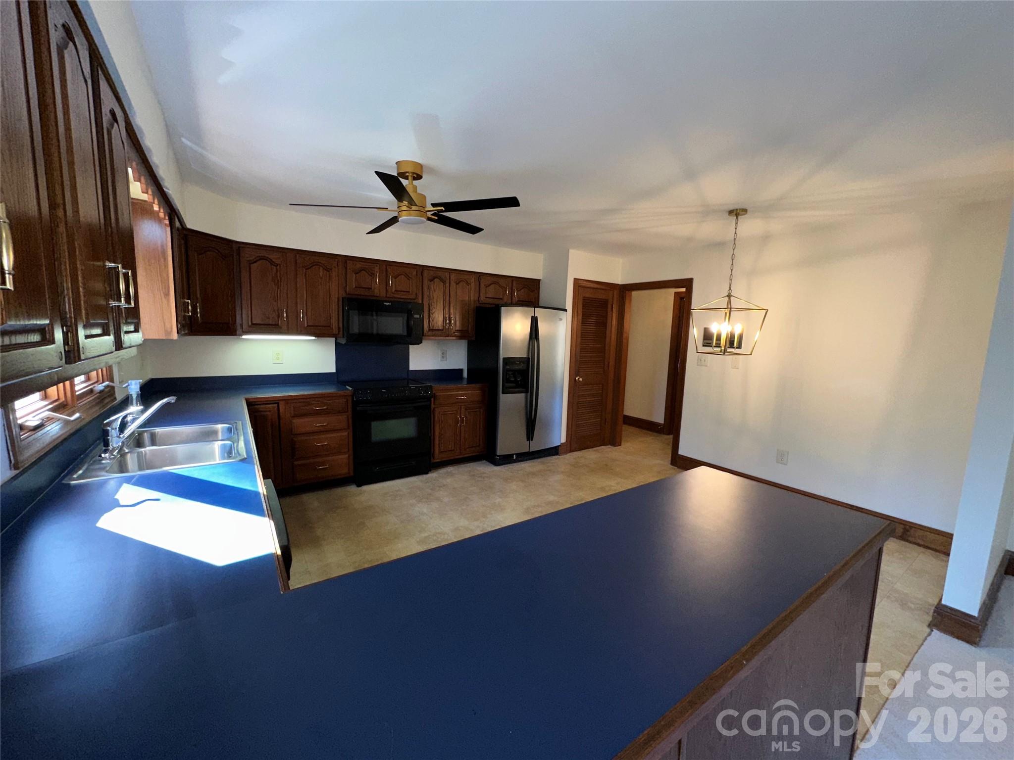 5143 Mintridge Road Mint Hill, NC 28227 - Photo 8 of 35 a view of a livingroom with furniture and a ceiling fan