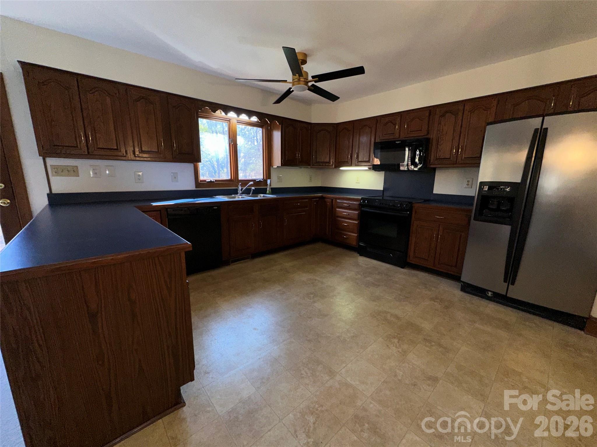5143 Mintridge Road Mint Hill, NC 28227 - Photo 10 of 35 a kitchen with granite countertop a refrigerator stove top oven and sink