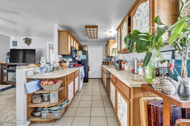 a kitchen with furniture a refrigerator and sink