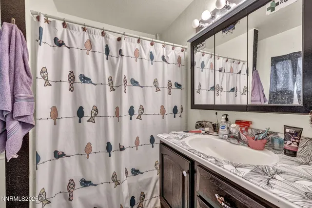 a bedroom with baby bed and window