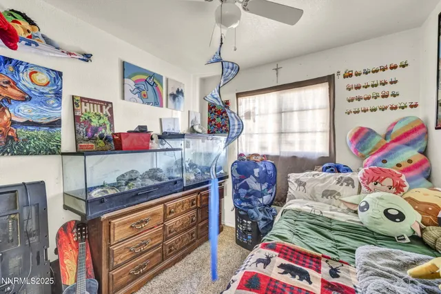 a bedroom with two beds and a bed