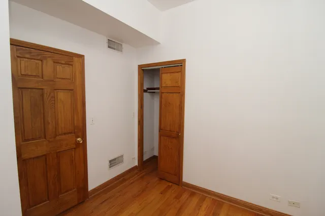 an empty room with wooden floor