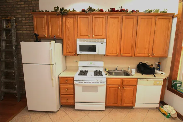 a kitchen with a stove a refrigerator and cabinets