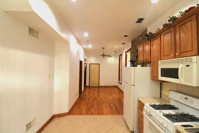a kitchen with stainless steel appliances granite countertop a refrigerator and a stove top oven