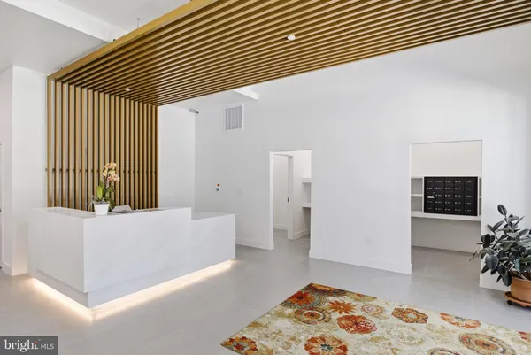 a view of a hallway with furniture