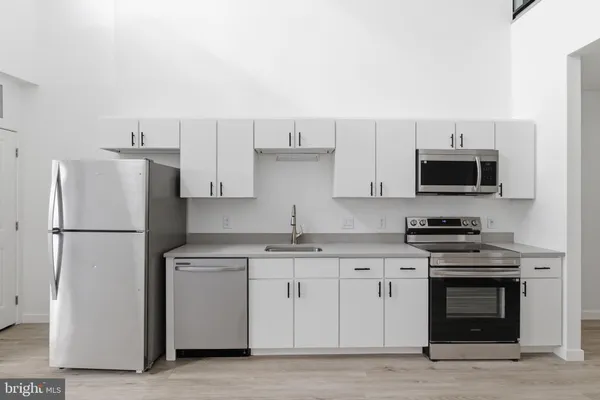 a kitchen with stainless steel appliances granite countertop a refrigerator stove a sink and dishwasher