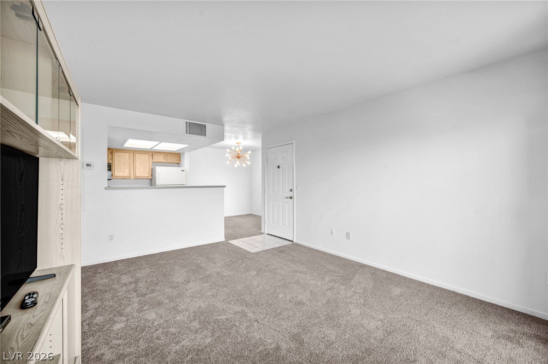 8070 West Russell Road, Unit 2060 Las Vegas, NV 89113 - Photo 9 of 47 This living area flows into the kitchen, providing a versatile and comfortable living space.