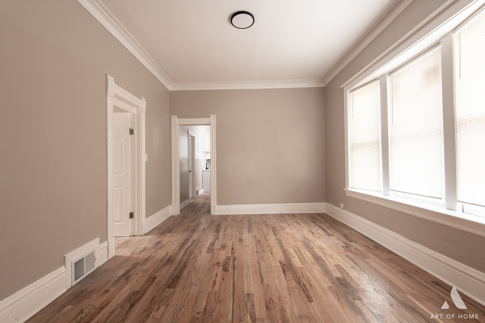 6511 South Justine Street Chicago, IL 60636 - Photo 10 of 28 a view of an empty room with wooden floor and a window