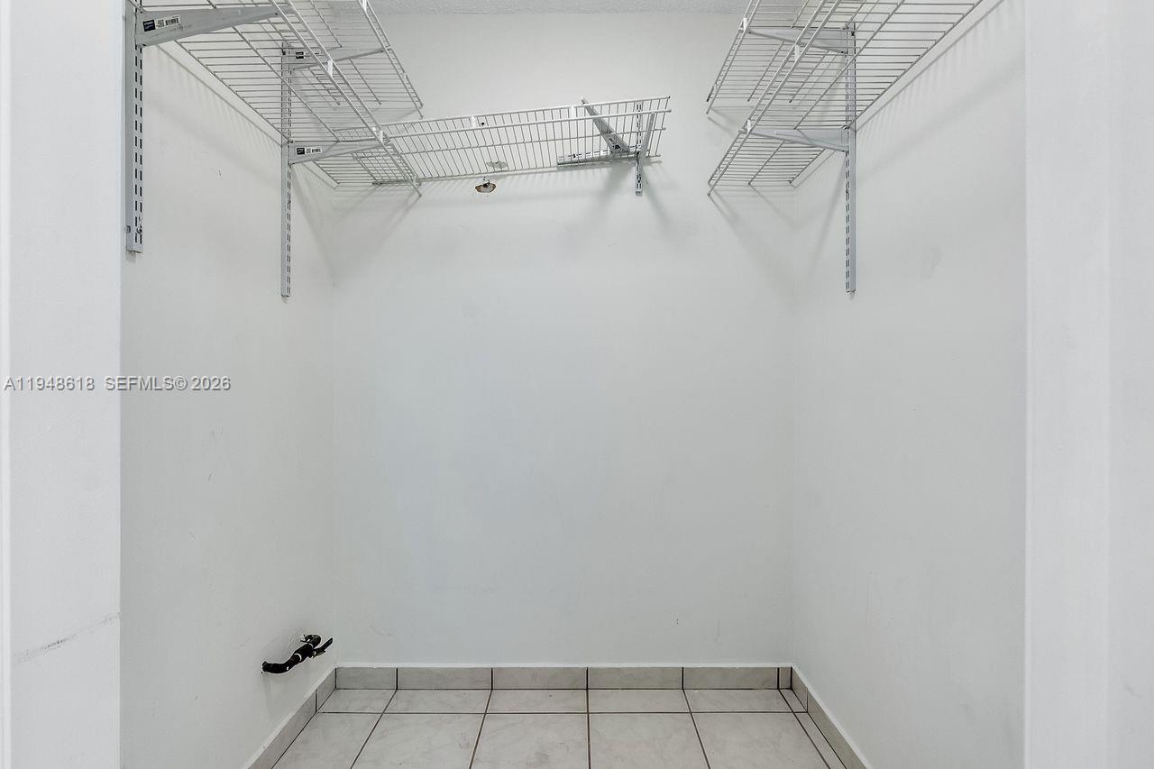 995 Southwest 84th Avenue, Unit 223 Miami, FL 33144 - Photo 12 of 25 a view of a room with racks on the wall