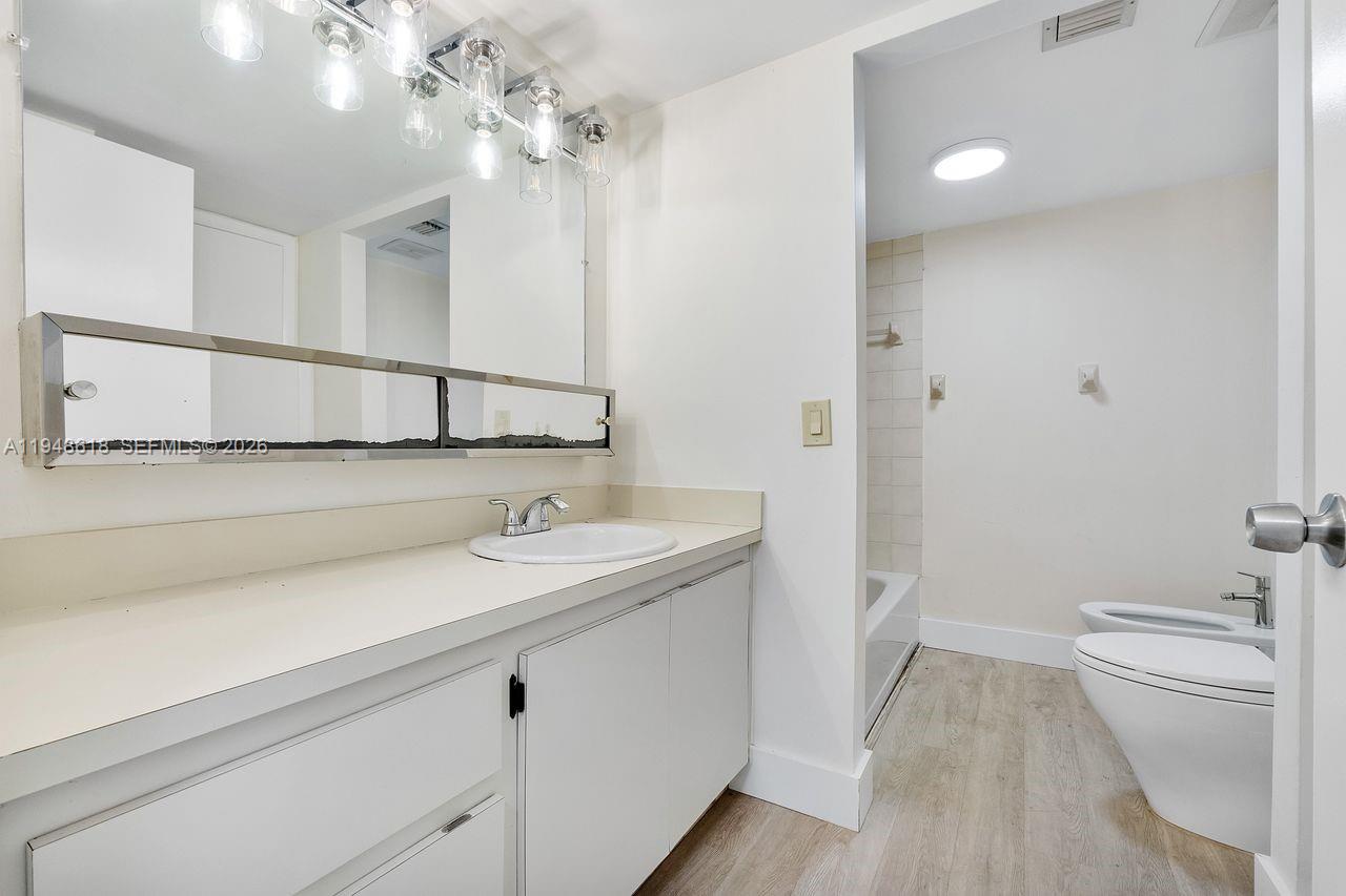 995 Southwest 84th Avenue, Unit 223 Miami, FL 33144 - Photo 13 of 25 a bathroom with a sink a toilet and shower