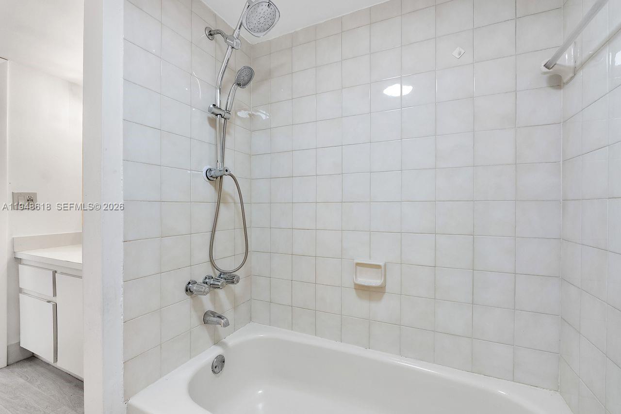 995 Southwest 84th Avenue, Unit 223 Miami, FL 33144 - Photo 15 of 25 a bathroom with a bath tub with a shower