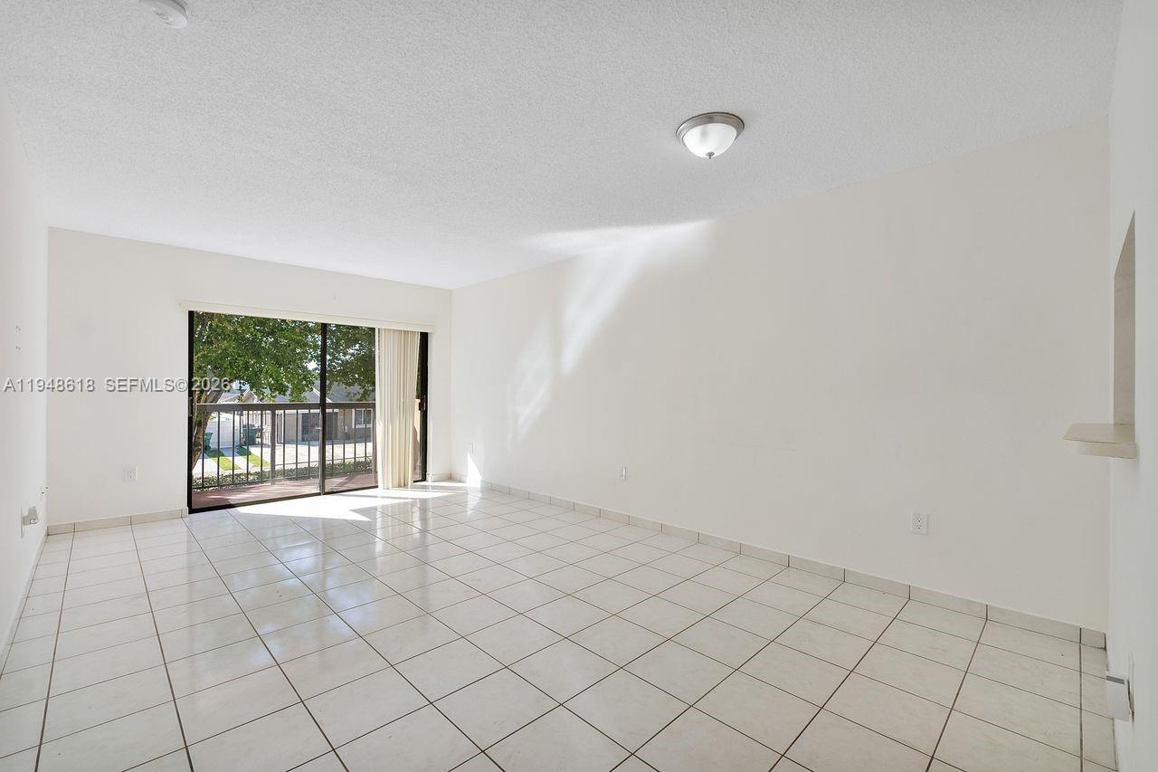 995 Southwest 84th Avenue, Unit 223 Miami, FL 33144 - Photo 16 of 25 a view of an empty room with a window