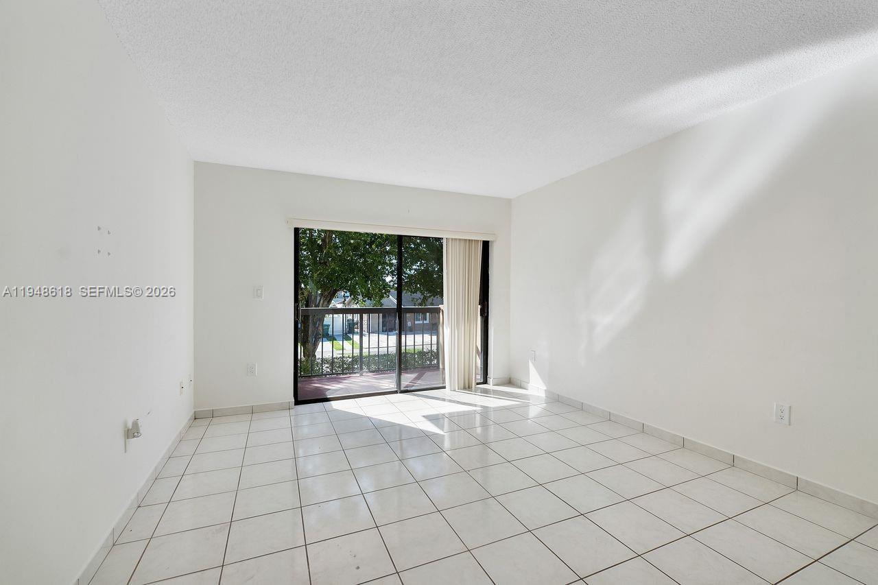 995 Southwest 84th Avenue, Unit 223 Miami, FL 33144 - Photo 18 of 25 a view of an empty room with a window