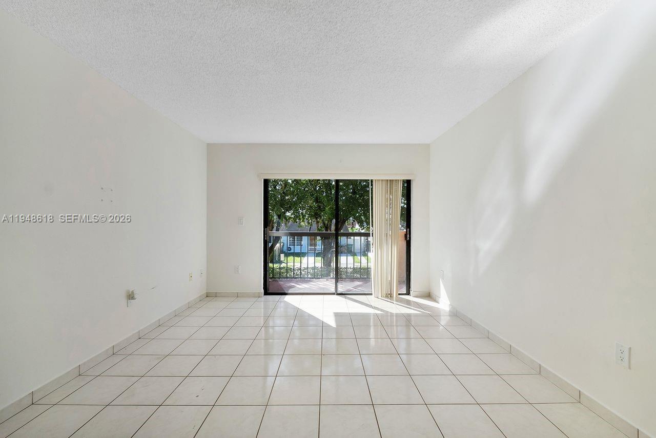 995 Southwest 84th Avenue, Unit 223 Miami, FL 33144 - Photo 19 of 25 a view of an empty room with a window