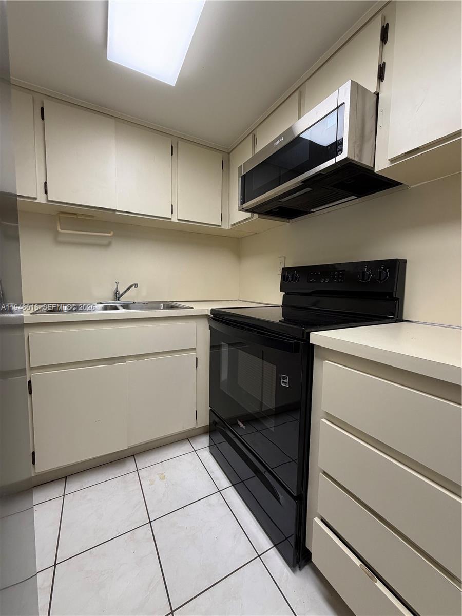 995 Southwest 84th Avenue, Unit 223 Miami, FL 33144 - Photo 7 of 25 a utility room with sink dryer and cabinets
