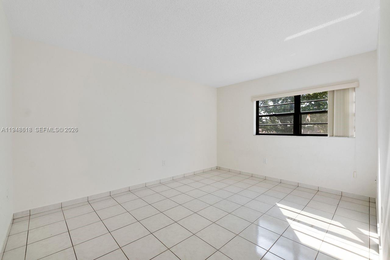 995 Southwest 84th Avenue, Unit 223 Miami, FL 33144 - Photo 8 of 25 an empty room with windows