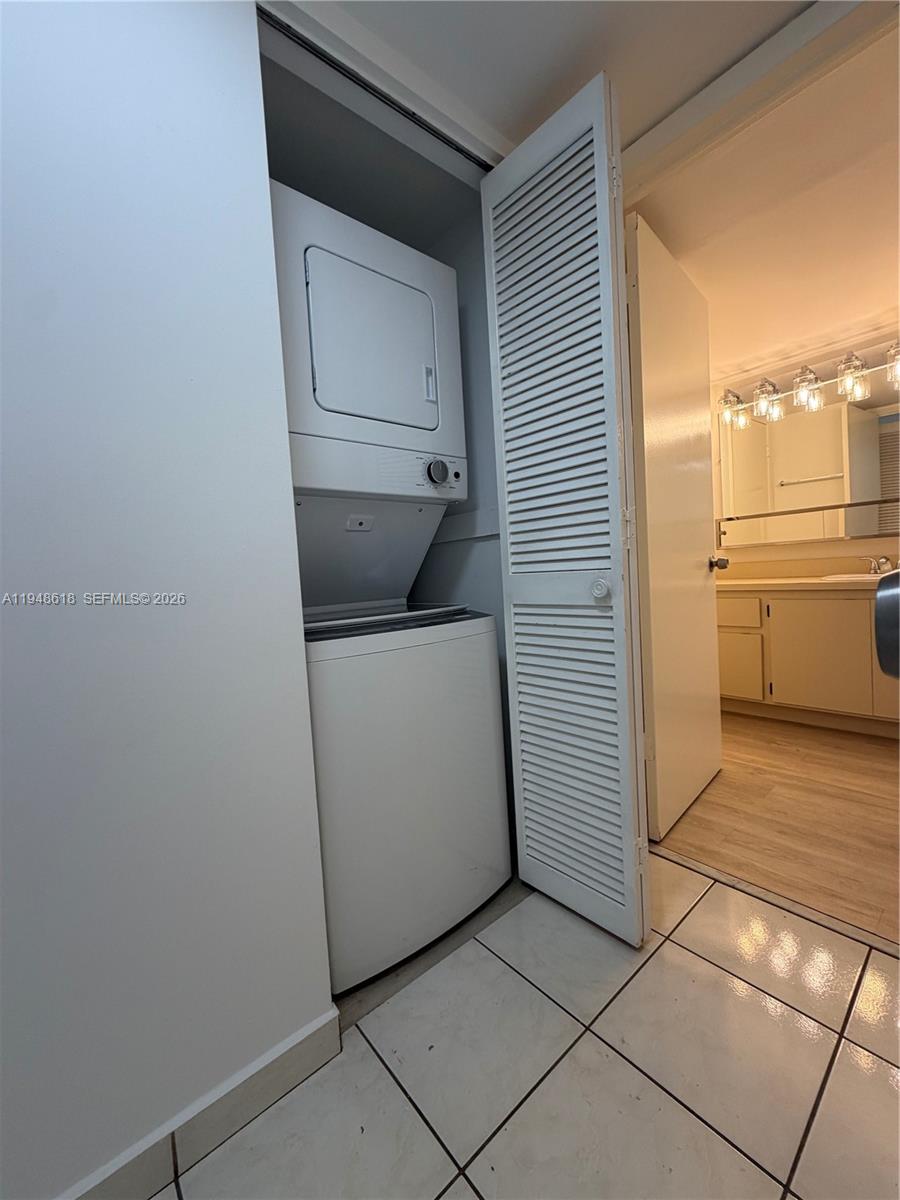 995 Southwest 84th Avenue, Unit 223 Miami, FL 33144 - Photo 10 of 25 a utility room with cabinets washer and dryer