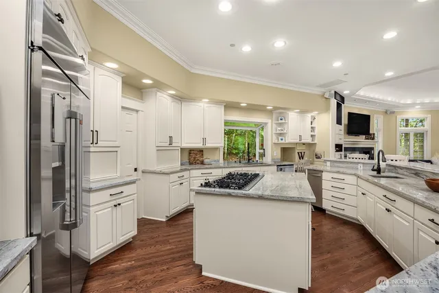 a kitchen with white cabinets and appliances