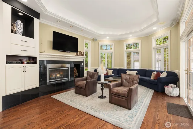 a living room with furniture a flat screen tv and a fireplace