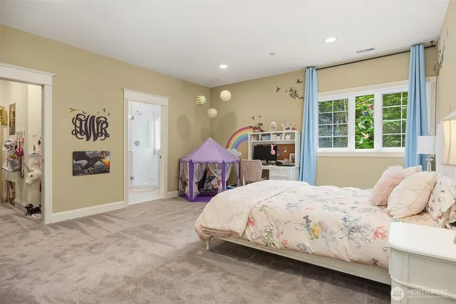 a bedroom with a large bed and a window