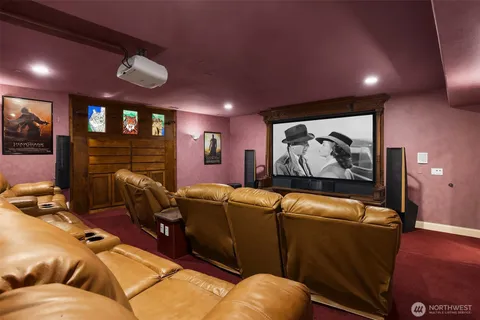 a media room with lots of chairs and a projector screen