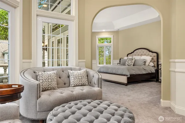 a bedroom with furniture and a large window