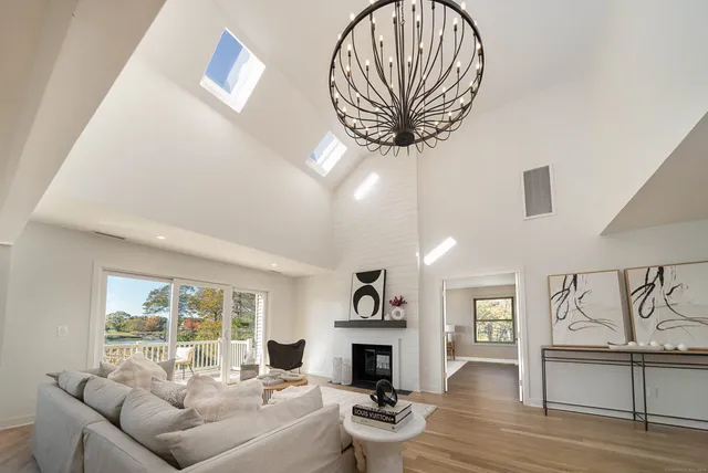a living room with furniture a fireplace and a table