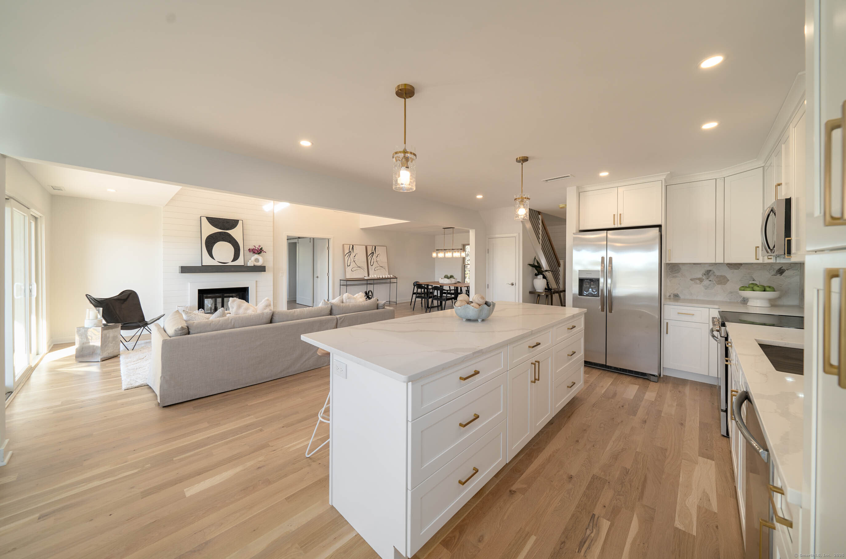 74 Quarry Dock Road, Unit 74 Branford, CT 06405 - Photo 17 of 37 a large white kitchen with a large counter top a sink stainless steel appliances and cabinets