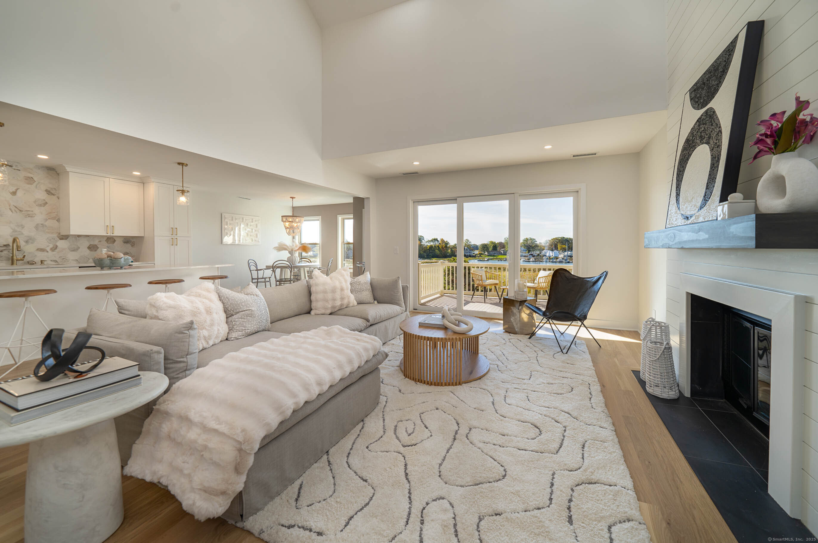 74 Quarry Dock Road, Unit 74 Branford, CT 06405 - Photo 2 of 37 a living room with furniture a fireplace and a large window