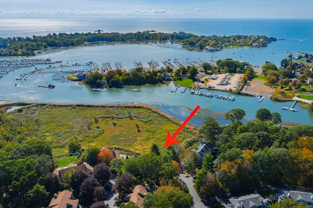 an aerial view of beach and residential houses with outdoor space