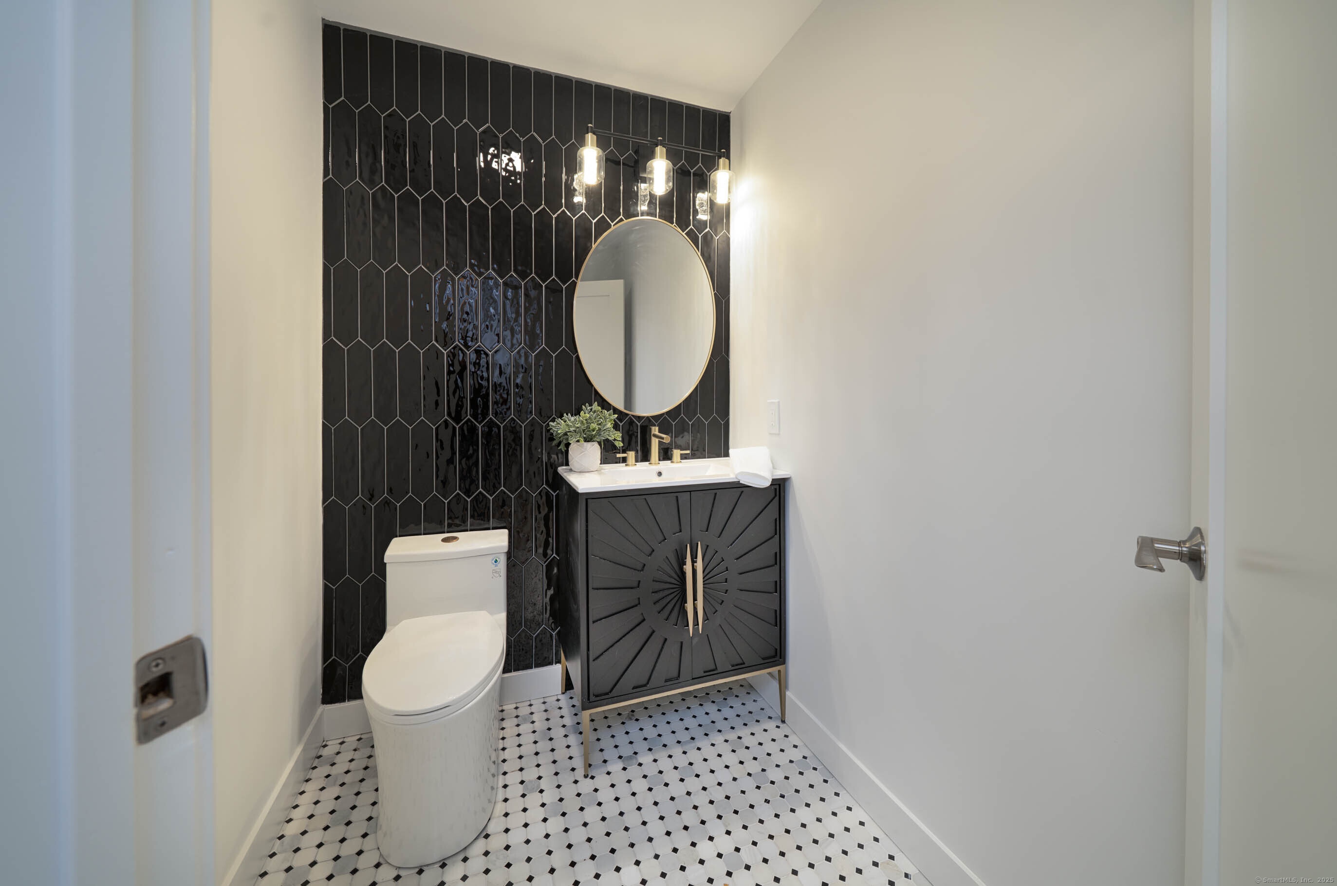 74 Quarry Dock Road, Unit 74 Branford, CT 06405 - Photo 21 of 37 a bathroom with a toilet a sink and a mirror