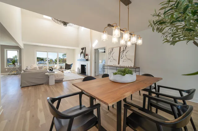 a view of a dining room with furniture and a chandelier
