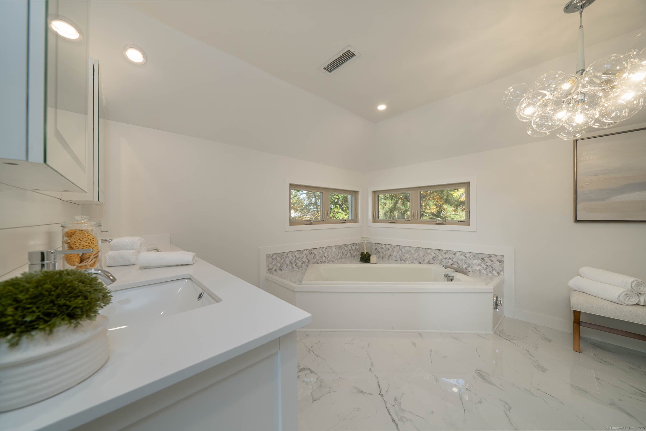 74 Quarry Dock Road, Unit 74 Branford, CT 06405 - Photo 31 of 37 a bathroom with a sink a large mirror and a bathtub