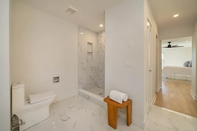 a bathroom with a toilet and a shower
