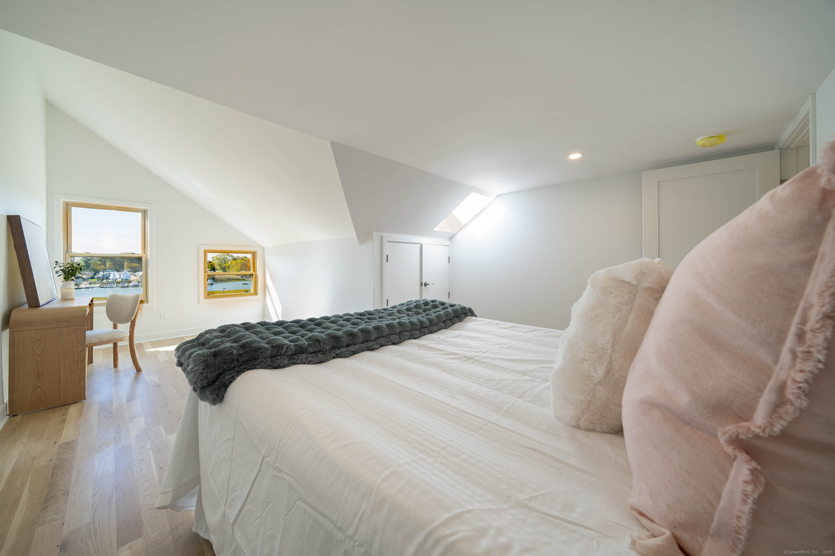 74 Quarry Dock Road, Unit 74 Branford, CT 06405 - Photo 34 of 37 a bedroom with a bed and wooden floor