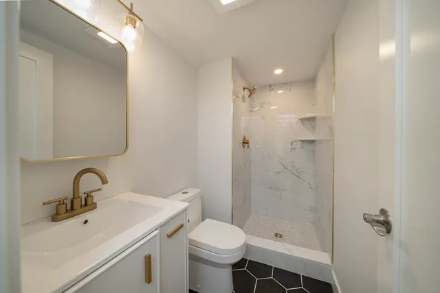 a bathroom with a sink toilet and shower