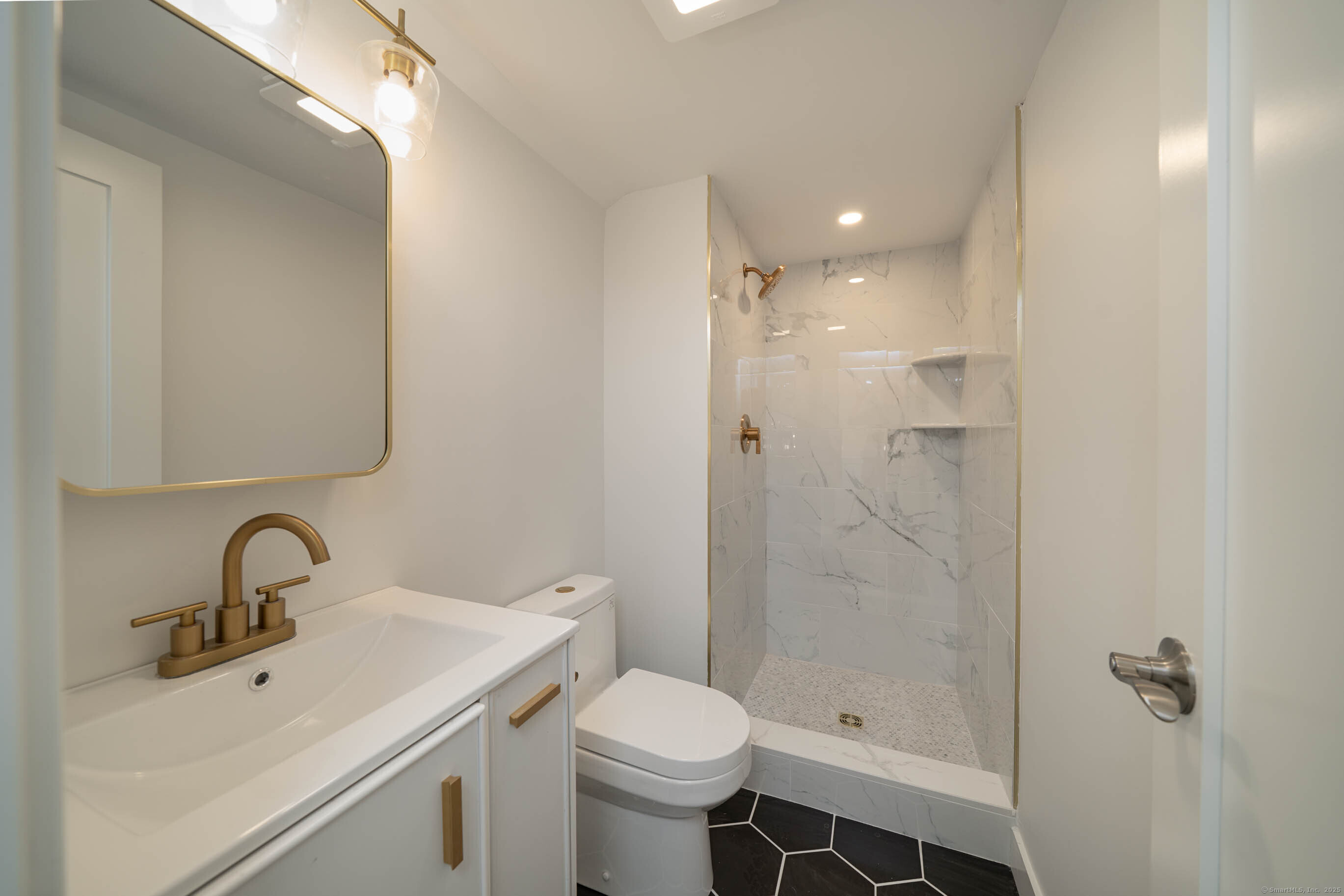 74 Quarry Dock Road, Unit 74 Branford, CT 06405 - Photo 36 of 37 a bathroom with a sink toilet and shower