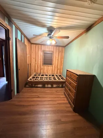 a view of a room with wooden floor and furniture
