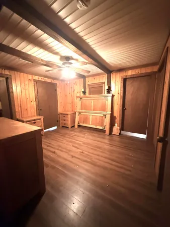 a view of a room with wooden floor