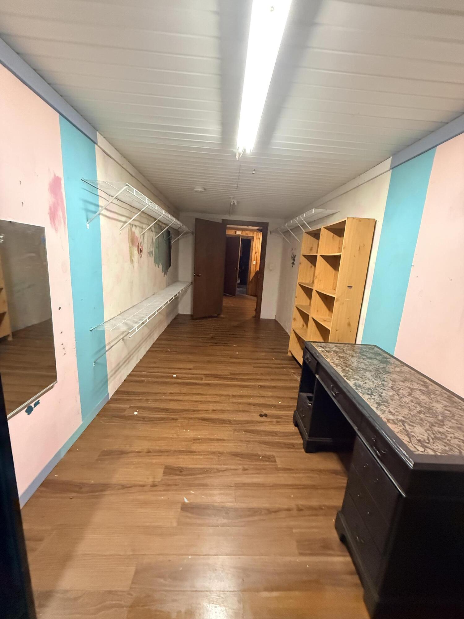 2483 Jordan Road Flomaton, AL 36441 - Photo 16 of 28 a view of an empty room with wooden floor and furniture